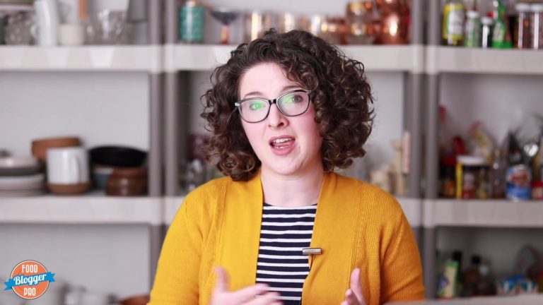 Emily Caruso speaking in front of photography props