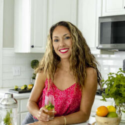 Aleka Shunk in a kitchen holding a drink