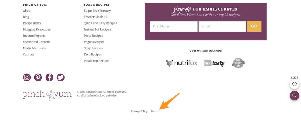 the footer of the Pinch of Yum website with an arrow pointing to the Terms of Service link