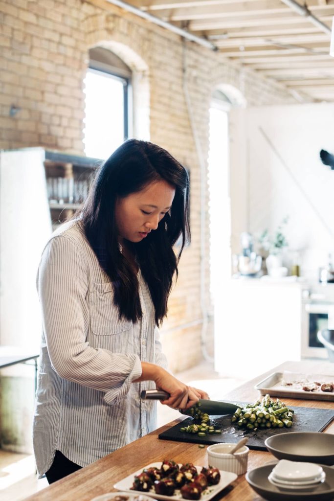 Woman chopping vegetables on a cutting board
