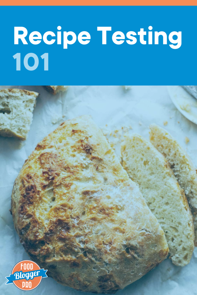 A loaf of cheesy bread that reads "recipe testing 101" and has the Food Blogger Pro logo on it.